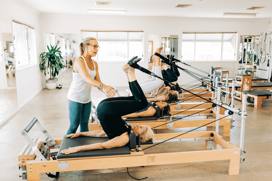 Trainer Instructing Pilates Students — Pilates Studio In Albany Creek, QLD